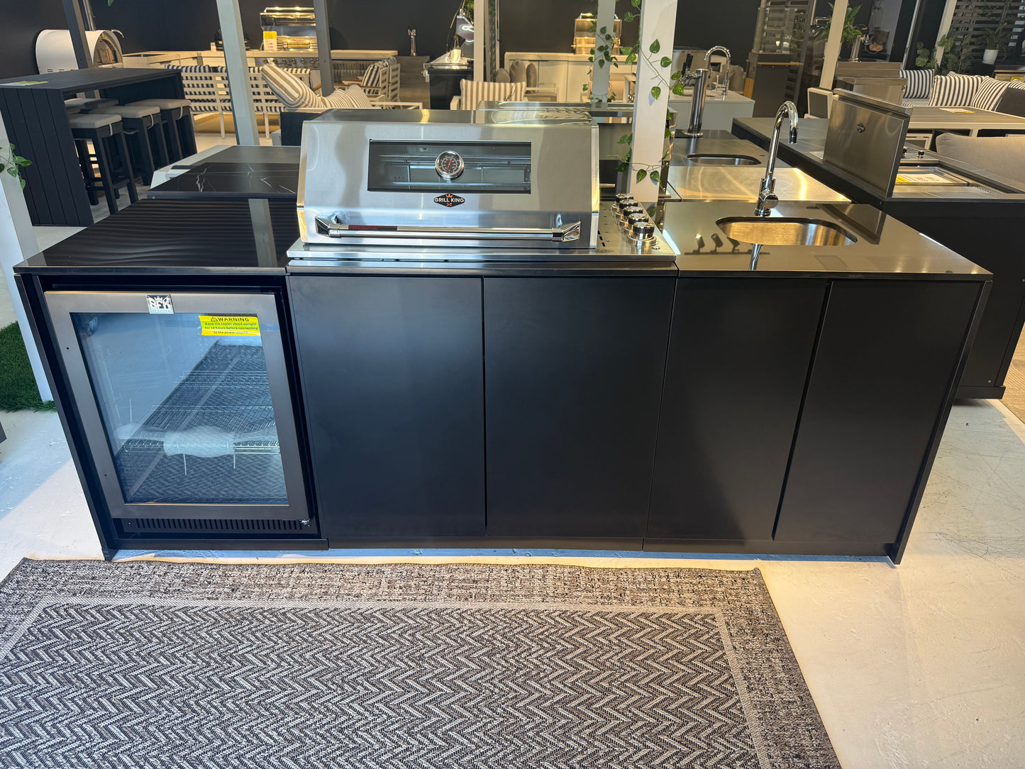 Grill King Signature Series Outdoor BBQ Kitchen Package – Rockpool Black Stone Bench-Top, Black Aluminium Cabinets | 4-Burner Built-In BBQ + Rotisserie + 150L Outdoor Fridge