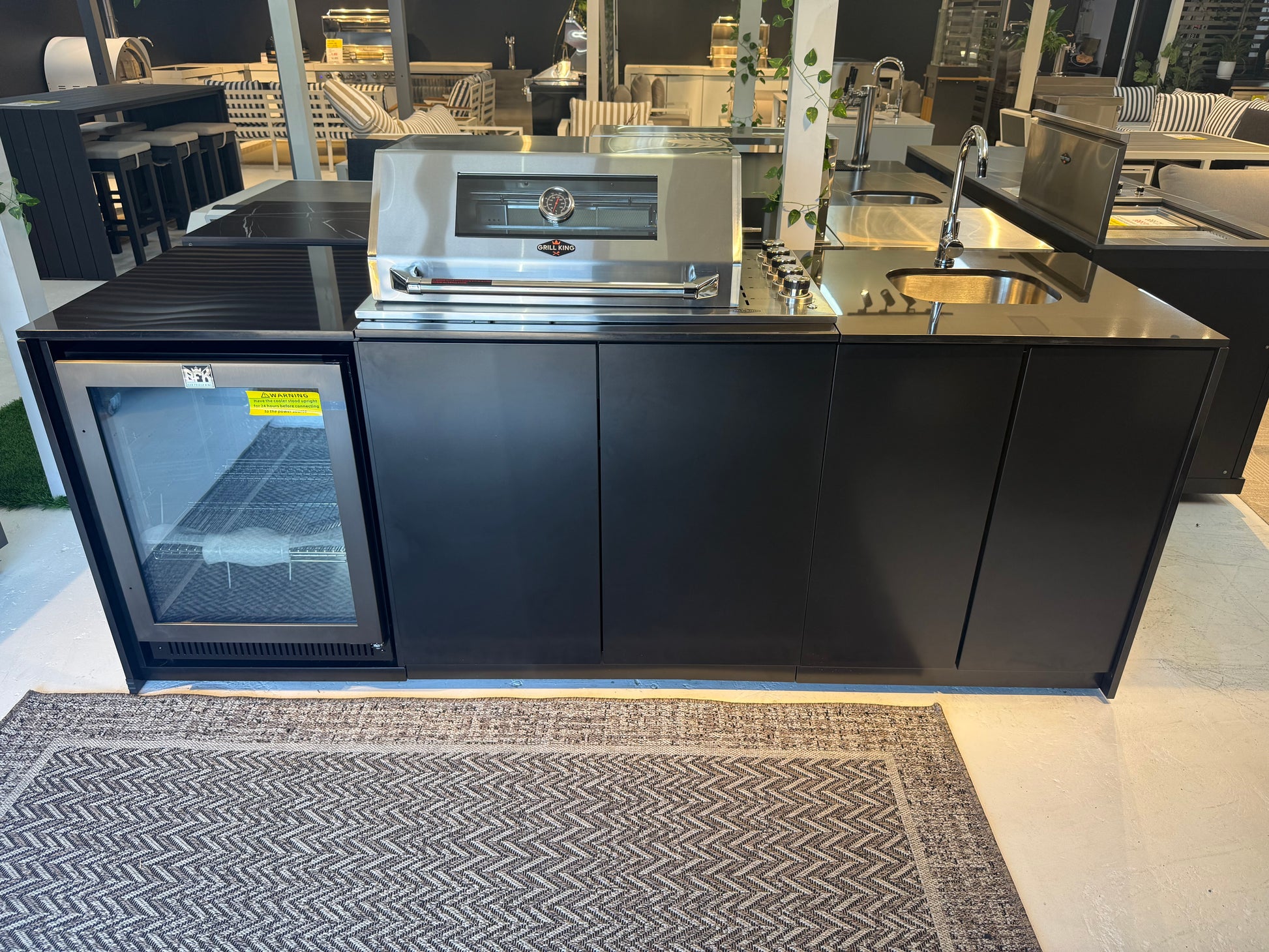 Grill King Signature Series Outdoor BBQ Kitchen Package – Rockpool Black Stone Bench-Top, Black Aluminium Cabinets | 4-Burner Built-In BBQ + Rotisserie + 150L Outdoor Fridge